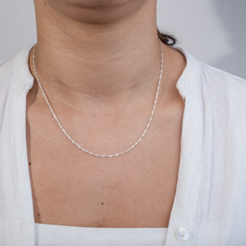 Modelo feminina usando um colar singapura em prata 925