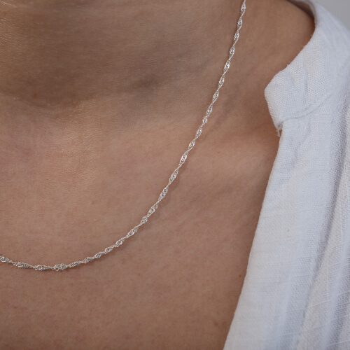 Modelo feminina usando um colar singapura em prata 925